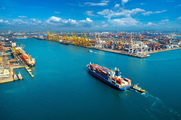 Aerial view of a modern seaport with container ships, cargo terminals, and shipping operations representing a marine logistics course focused on port management, maritime transport, and global supply chain operations.