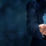 Business professional holding a group of employee icons in hands, representing leadership, talent management, and human resource strategy.