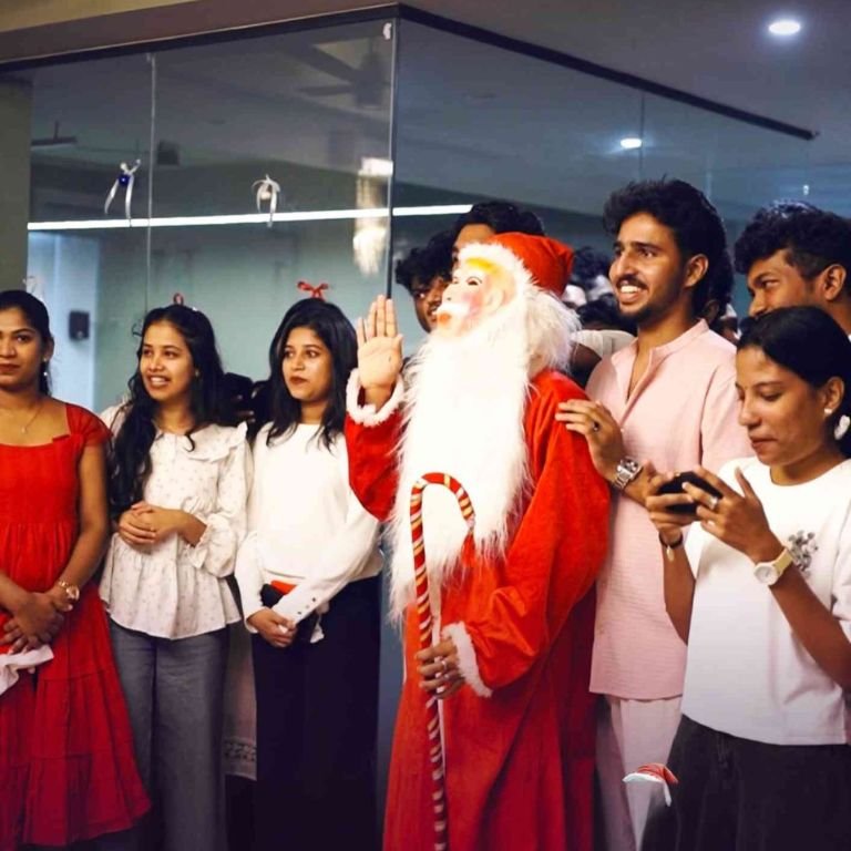 Students gathered around a person dressed as Santa Claus during a festive celebration in the best logistics institute in kerala, highlighting campus life and student engagement activities.