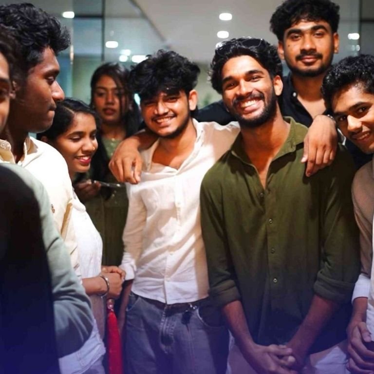 Group of students smiling and posing together indoors in the best logistics institute in kerala, showcasing friendship, community, and campus life experience.